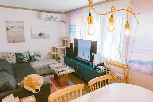 een woonkamer met een bank en een tv bij Vivir Stay Seoul in Seoul