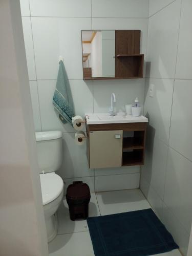 a bathroom with a toilet and a sink and a mirror at Aconchego da Kika in Caruaru
