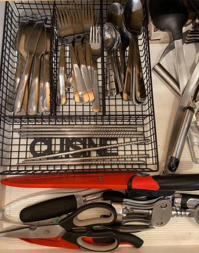 a wire basket filled with utensils on a table at Lux 2BR 5BD Suite Mountain view! in Canmore