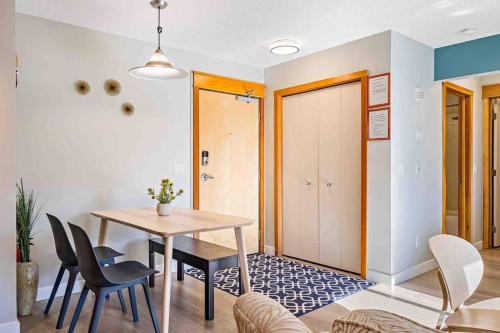a dining room with a table and chairs at Lux 2BR 5BD Suite Mountain view! in Canmore
