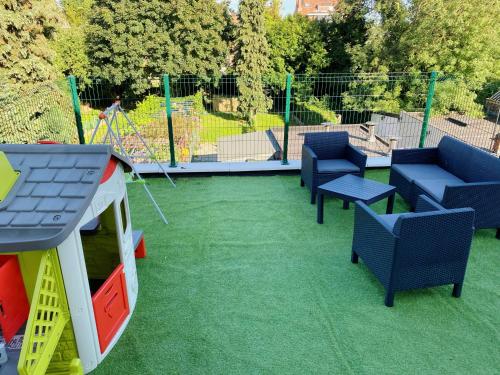 a playground with chairs and a play set on the grass at Sweet home with big terrace in Brussels