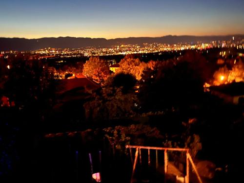 a view of a city at night with lights at Cabane Jacomeli Genève in Collonges-sous-Salève
