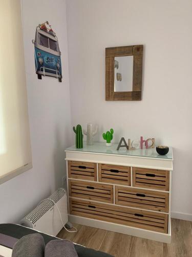a room with a dresser with a van on the wall at Lovely house near the beach in Calafell