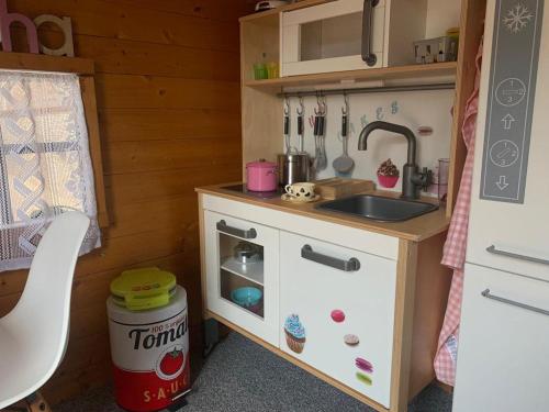 a small kitchen with a sink and a stove at Lovely house near the beach in Calafell