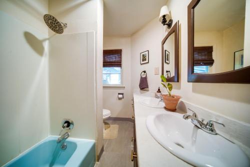 a bathroom with a sink and a mirror at Stylish Willoughby Hills Retreat with Fireplace! 
