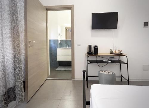 a bedroom with a bed and a bathroom with a sink at Affittacamere Everest in La Spezia