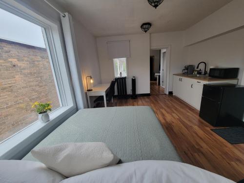 a living room with a bed and a large window at Stone House Kenora in Kenora