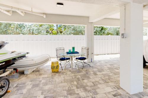 a patio with a table and a boat on it at Ocean Isles #119 in Marathon