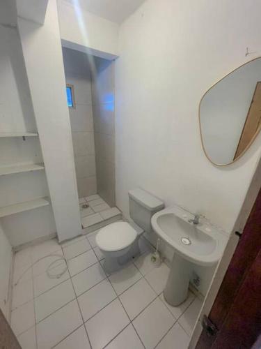 a bathroom with a toilet and a sink and a mirror at Centrico Departamento en Santa Cruz de la Sierra in Santa Cruz de la Sierra