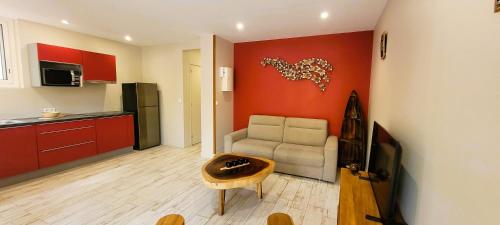 a living room with a couch and a table at Soley'Caraibes III in Les Trois-Îlets