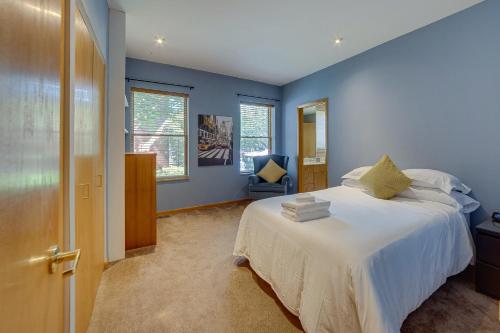 a bedroom with a large bed with blue walls at Central West End Condo Less Than 1 Mi to Forest Park! in Tower Grove