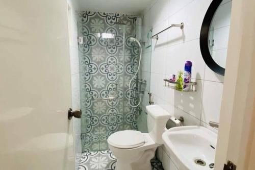 y baño con aseo, lavabo y ducha. en Hillside Homestay Subic-Fully Furnished House 3BR en Subic