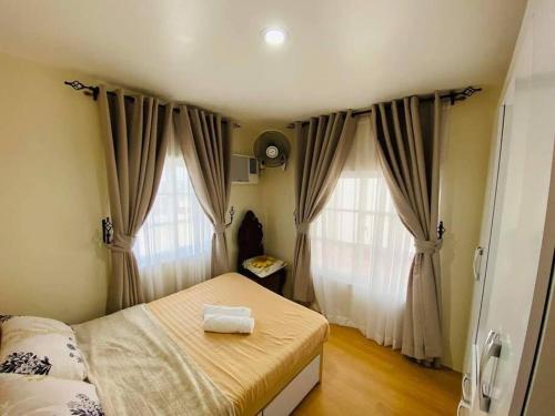 A bed or beds in a room at Hillside Homestay Subic-Fully Furnished House 3BR