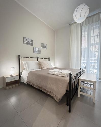 a white bedroom with a bed and a window at Affittacamere Everest in La Spezia