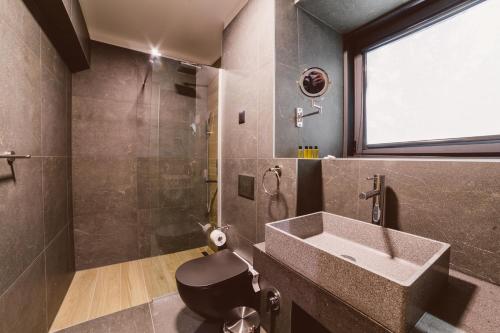 a bathroom with a sink and a shower at Hotel Boutique Anoma in Sarajevo