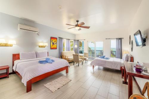 a bedroom with two beds and a living room at Parrot Cove Lodge in Hopkins