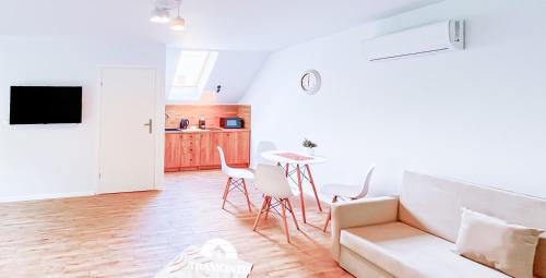 a living room with a couch and a table at Tramonto Apartments Zator Przeciszów in Zator