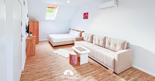 a living room with a couch and a table at Tramonto Apartments Zator Przeciszów in Zator