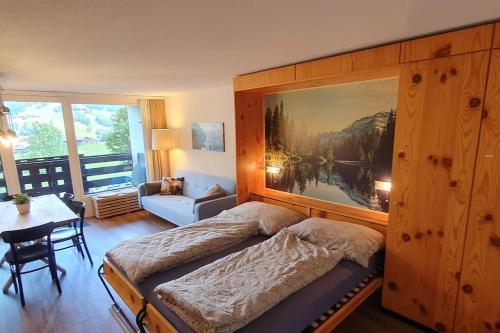 una camera da letto con un letto con un grande dipinto sul muro di Stilvolle Wohnung mit traumhaftem Bergblick a Disentis