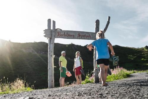 a group of people walking on a dirt road at RUHESTUBE - Cozy Apartment with Balcony & Parking in Zillertal, presented by AlpenLuxus in Fügen
