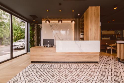 a lobby with a reception desk with a laptop on it at Hotel Boutique Anoma in Sarajevo