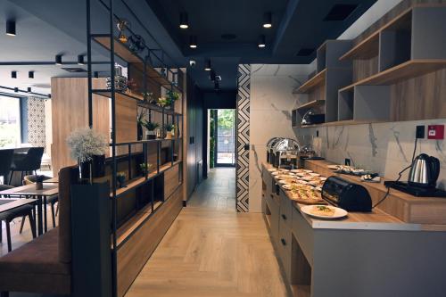 a kitchen with a counter and a table with food at Hotel Boutique Anoma in Sarajevo