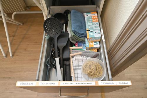 a drawer filled with cooking utensils in a room at Résidence Notre Dame in Châtellerault