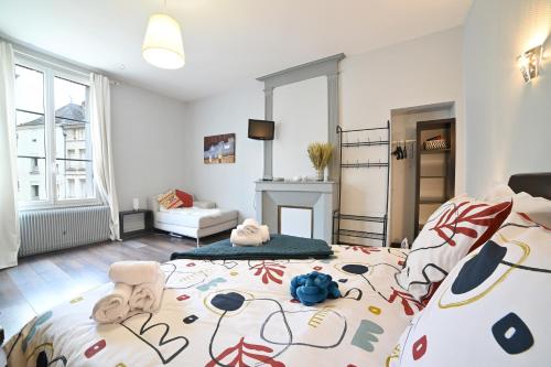 a bedroom with a large bed and a fireplace at Résidence Notre Dame in Châtellerault