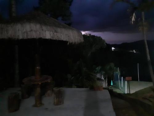 a night view of a building with a roof at CHACARA ENCANTO DO VALE in Mairinque