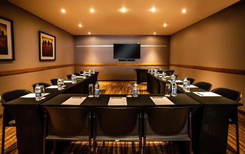 a conference room with a long table and chairs at Garden Court Kimberley in Kimberley
