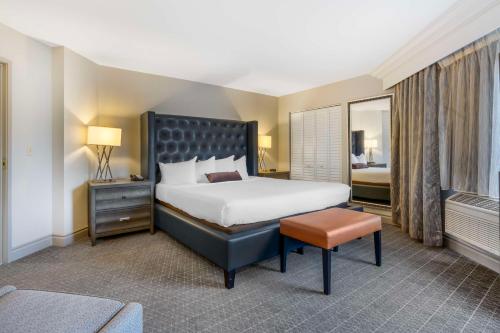 a bedroom with a large bed and a table at Best Western Plus Boomtown Casino Hotel in Reno