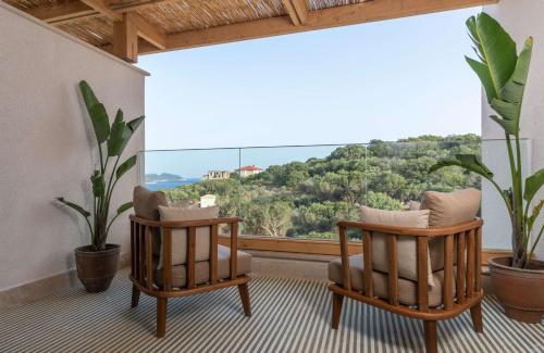 a room with two chairs and a large window at Radisson Blu Hotel, Kas in Kas