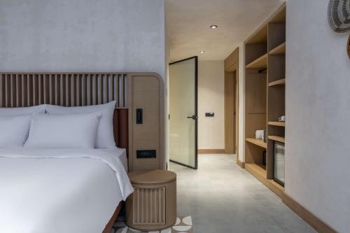 a bedroom with a bed and a walk in closet at Radisson Blu Hotel, Kas in Kas