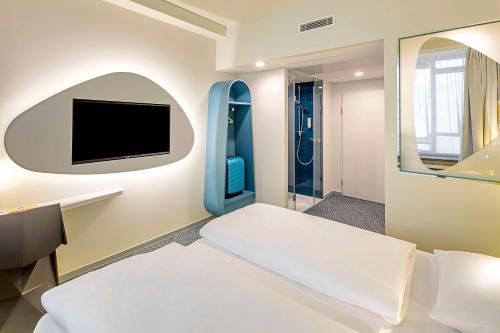 Ένα ή περισσότερα κρεβάτια σε δωμάτιο στο prizeotel Dortmund-City