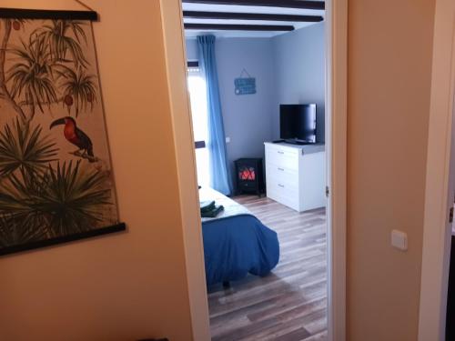 a room with a bedroom with a bed and a mirror at EL LLIMONER in Sant Jordi