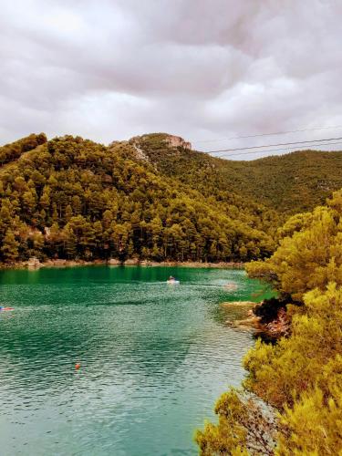 a boat on a lake in front of a mountain at EL LLIMONER in Sant Jordi