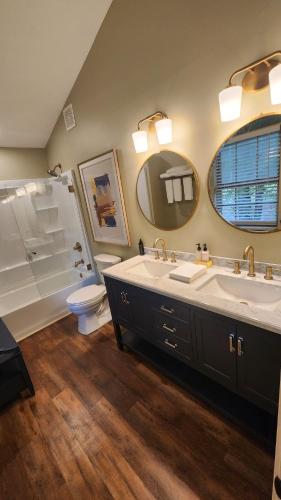 a bathroom with a sink and a tub and a toilet at Wolf Creek Lodge in Atlanta