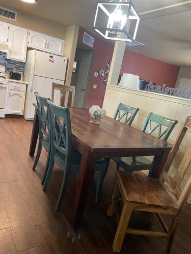 a wooden table and chairs in a kitchen with a refrigerator at All season vacation home! in Cottonwood