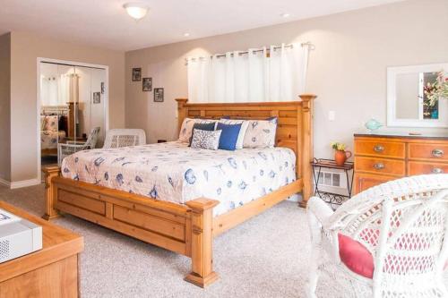 a bedroom with a wooden bed and a wooden dresser at Beach Retreat - A treat to be had by all! in Long Beach
