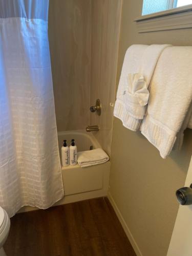 a bathroom with a shower with towels and a toilet at All season vacation home! in Cottonwood