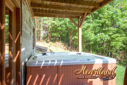 a hot tub sitting under a pergola at Halfway to Heaven in Sevierville