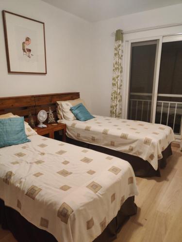 a bedroom with two beds and a window at Superb large private villa with pool in Prainha