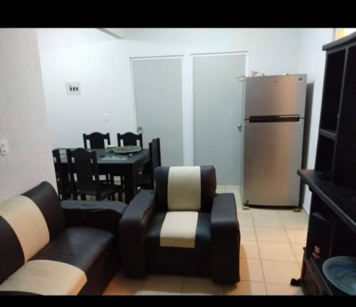 a living room with a couch and a refrigerator at Departamento ACAPULCO PROMOCIÓN in Aguacatillo