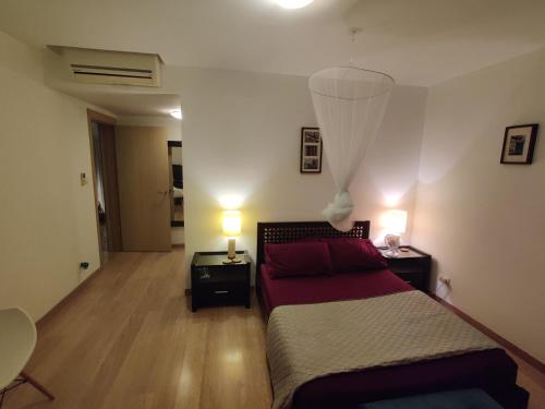 a bedroom with a bed and two tables and two lamps at Superb large private villa with pool in Prainha