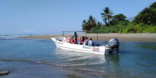 a group of people on a boat in the water at Casa Uvita Bay in Uvita