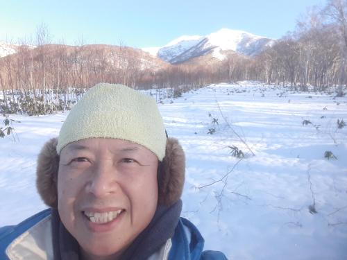 a man wearing a hat in the snow at Bistare Kana in Niseko