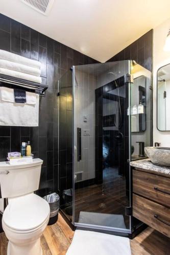 a bathroom with a toilet and a glass shower at Wilderness Lodge 1 bedroom cabin in the woods at Lake Wenatchee in Leavenworth