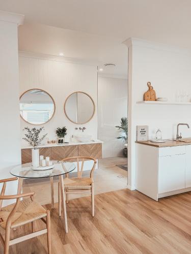 a kitchen and dining room with a table and chairs at Harrington Guest Suite in Harrington