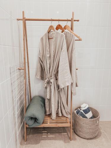 a towel rack with a robe on it in a bathroom at Harrington Guest Suite in Harrington