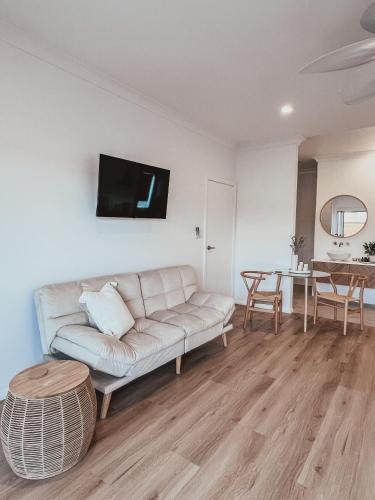 a living room with a couch and a table at Harrington Guest Suite in Harrington